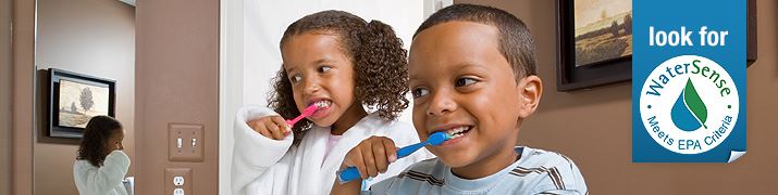 Two children brushing their teeth